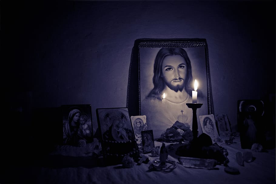 taper candle behind Jesus Christ photo, altar, light, faith, holy