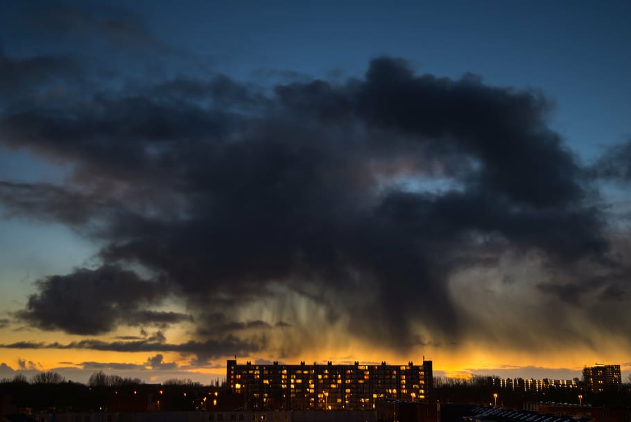 brown building under gray clouds during golden hour, rain cloud HD wallpaper