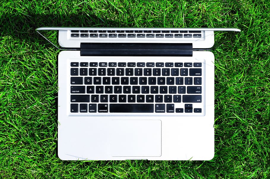 flat-lay photography of MacBook Air on top of green grass field HD wallpaper