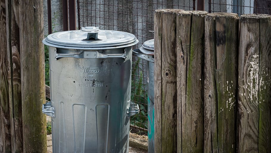 gray metal trash bin near fence, wooden fence, waste, litter