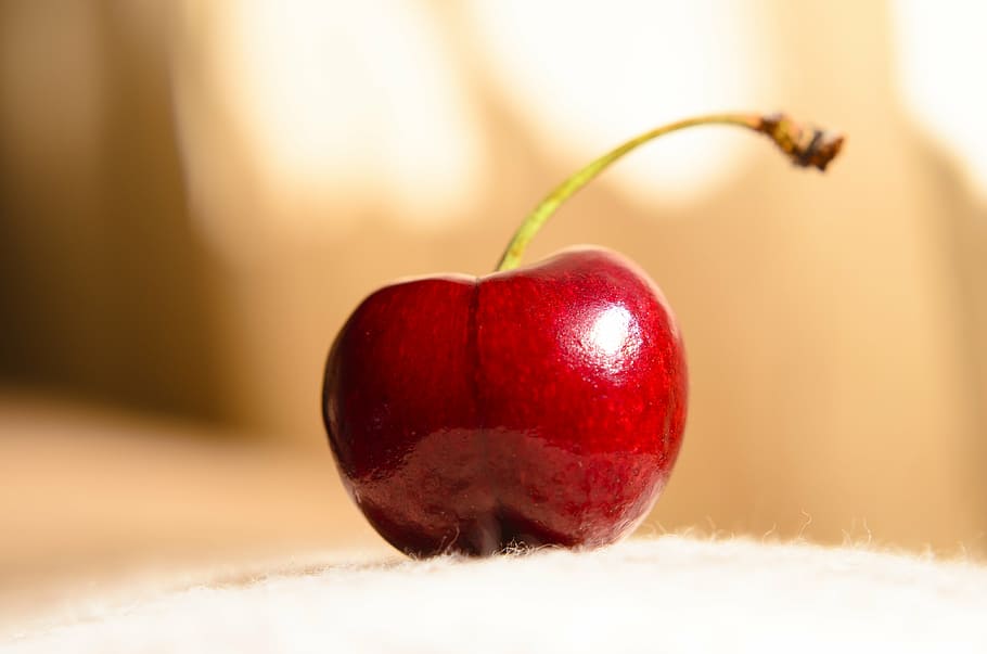 red cherry on white pad, fruit, grass, nature, stem, food and drink HD wallpaper
