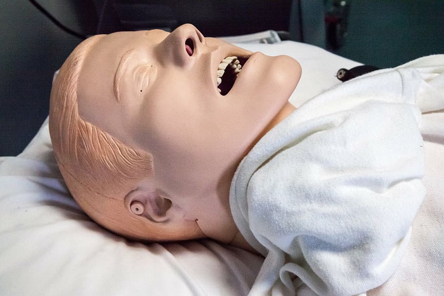 male head mannequin on white textile, paramedics doll, hospital