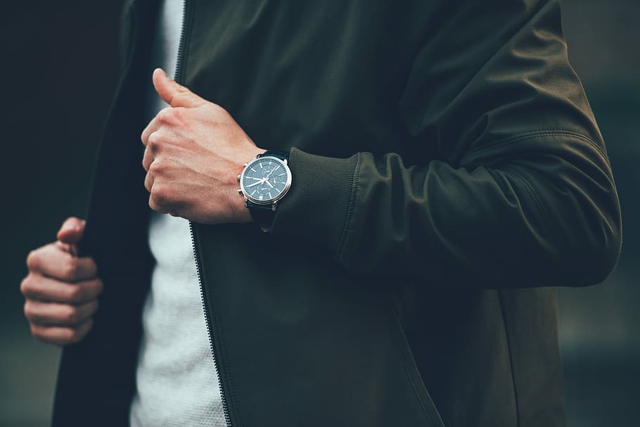 man wearing black jacket and holding it, man in black zip-up jacket and round black watch, HD wallpaper