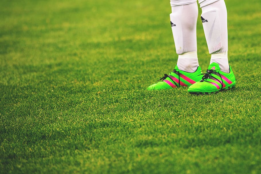 Feet and football boots of a male soccer player, people, fitness