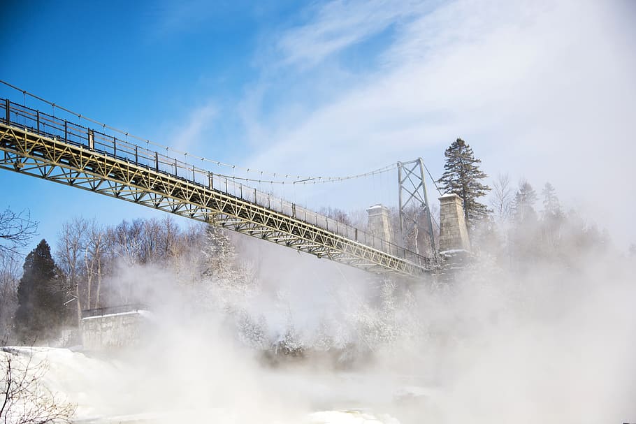 photo of brown bridge near trees and snow field, waterfall HD wallpaper