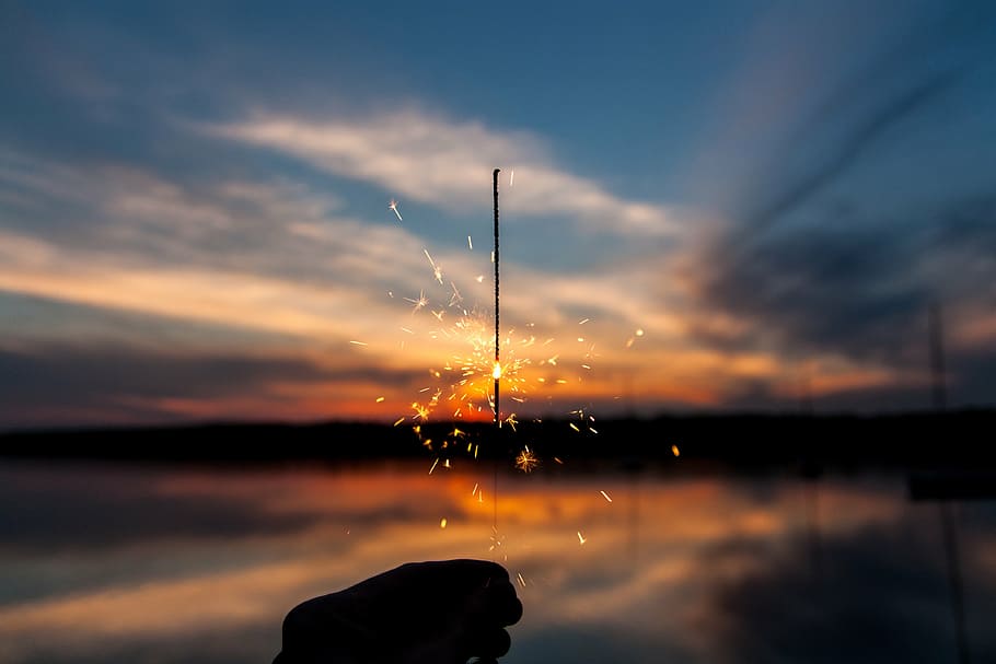 person holding roman candle, sparkler, lights, fire, flame HD wallpaper