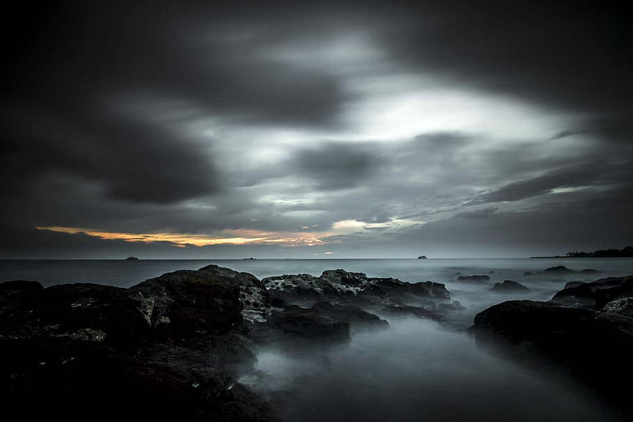 fog-covered rocks wallpaper, rock formations under cloudy sky during sunset HD wallpaper