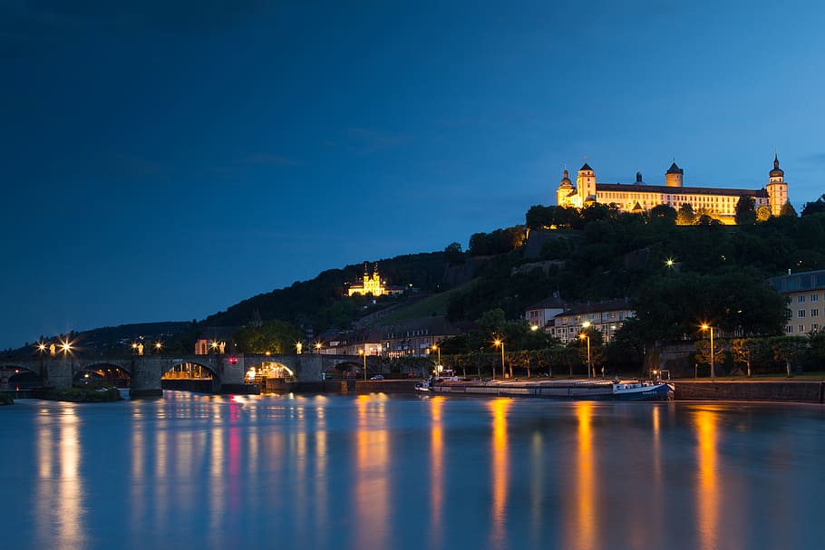 castle on hill near body of water during night time, würzburg