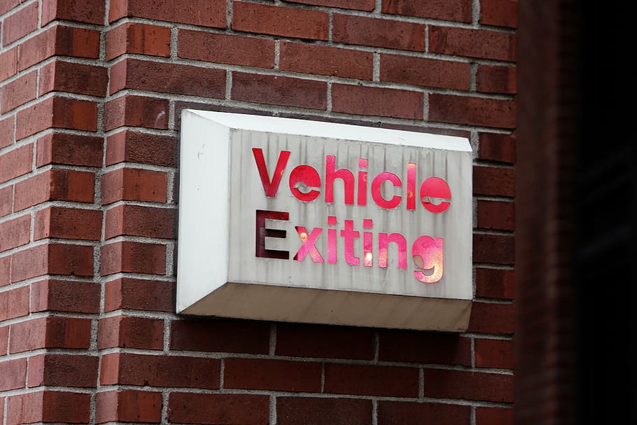 white and red vehicle exiting signage, bricks, brick wall, text HD wallpaper