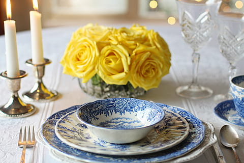 white and blue floral ceramic dinnerware on table with candles HD wallpaper