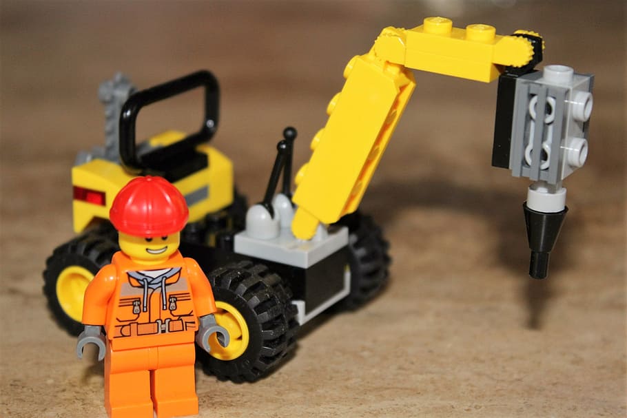 worker minifigure and heavy equipment building block toy placed on brown surface, HD wallpaper