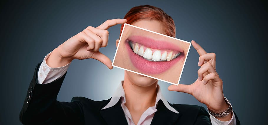 woman holding photo of teeth, smile, tooth, bless you, mouth