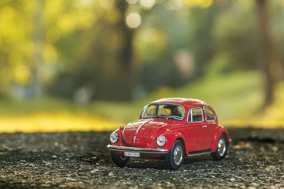 stilt shift red Volkswagen Beetle scale model selective focus photography
