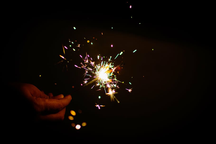 person holdiing multicolored sparkler, fireworks, colors, diwali, HD wallpaper
