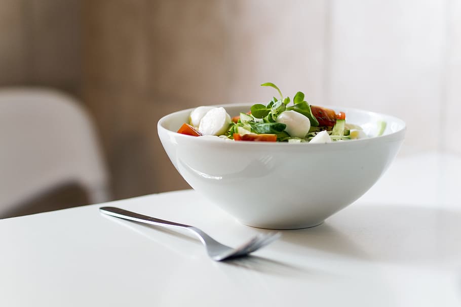 bowl of vegetable beside fork place on table, salad on white ceramic bowl beside silver fork, HD wallpaper