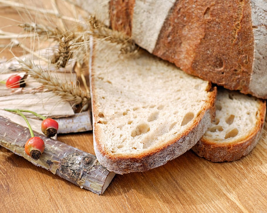 sliced bread beside wood sticks on brown wooden surface, wood oven bread HD wallpaper