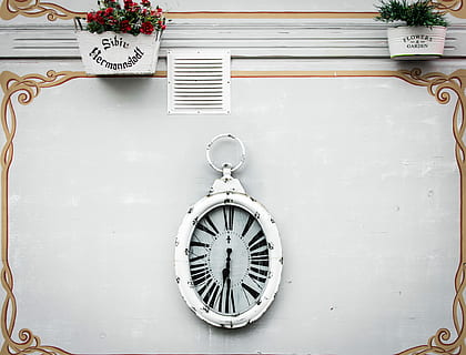 oval white analog clock display at 6 o'clock, white and black analog wall clock at 7:30 HD wallpaper