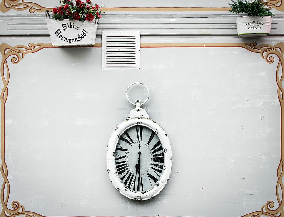 oval white analog clock display at 6 o'clock, white and black analog wall clock at 7:30 HD wallpaper