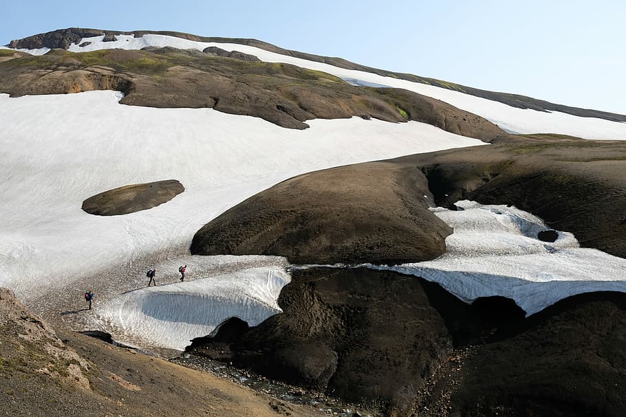 Hikers on the Laugavegur trail, brown rock formation, mountain side HD wallpaper