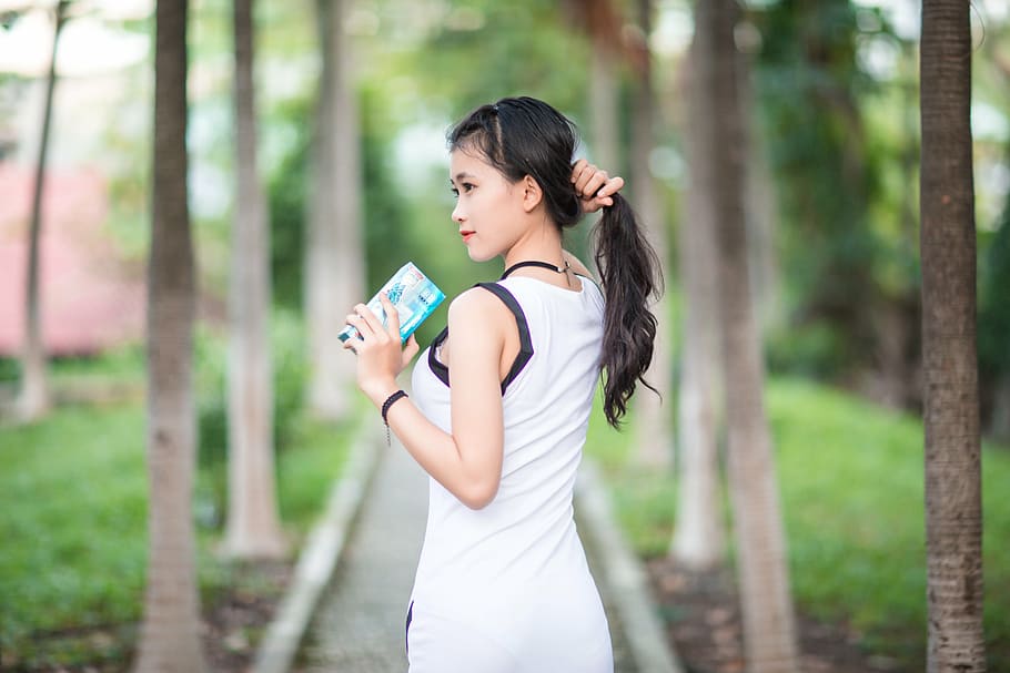 woman wearing white tank top holding hair and looking towards left, HD wallpaper