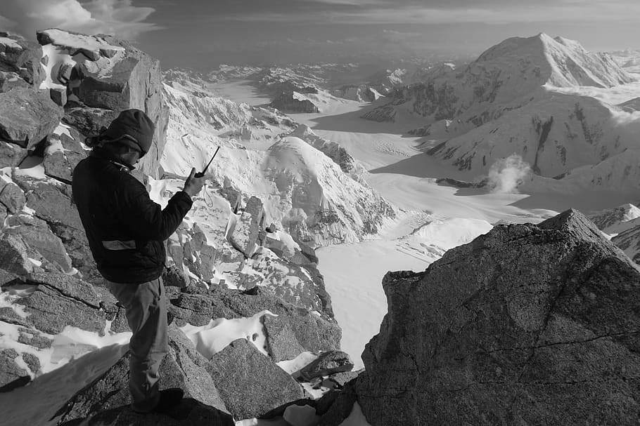 grayscale photography of man standing near cliff, landscape, mountaineering, HD wallpaper