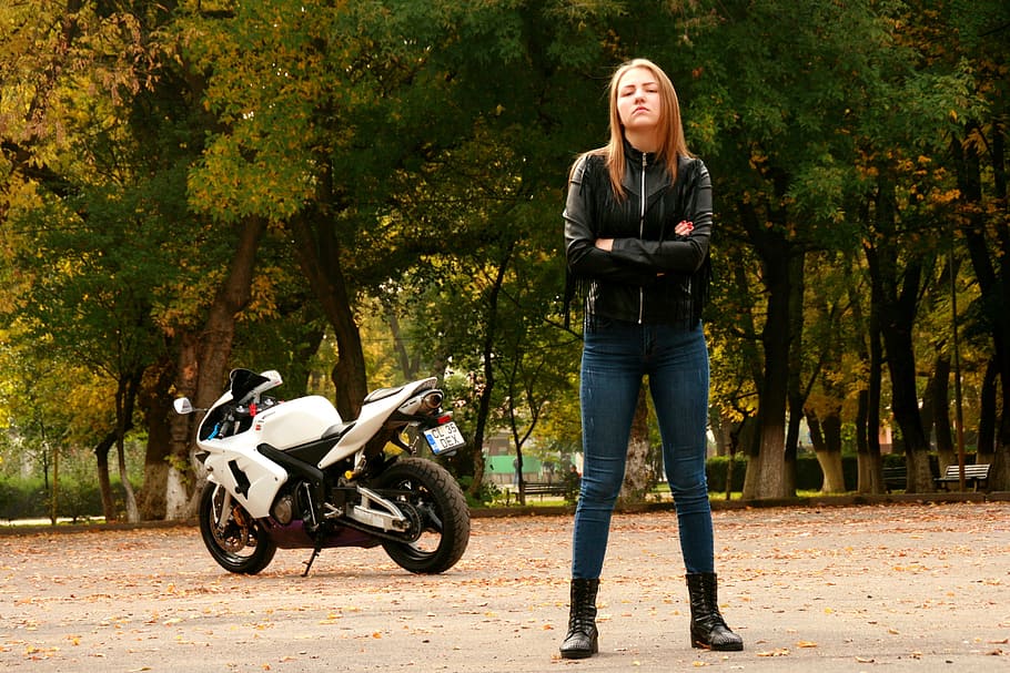 woman wearing black leather zip-up jacket with motorcycle, girl