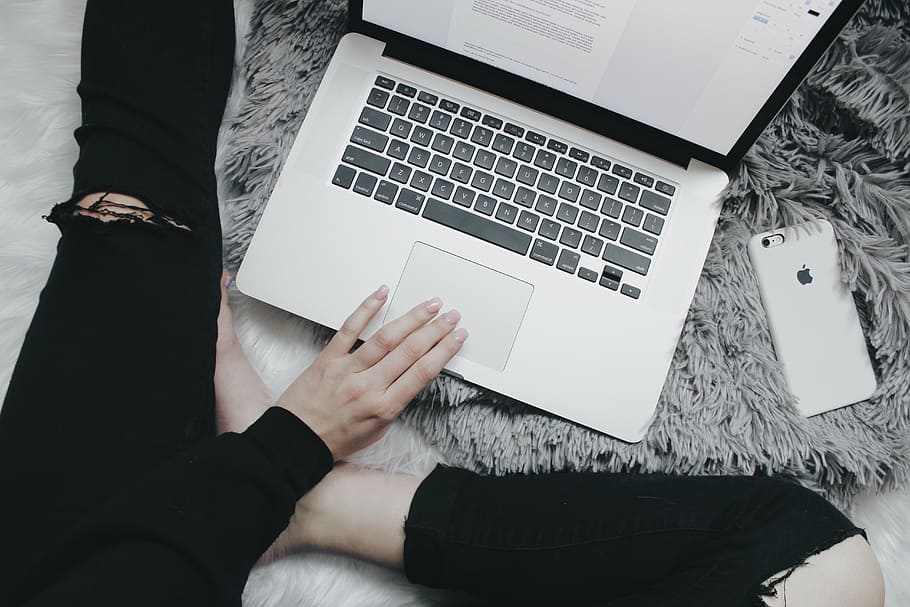 person using MacBook Pro on gray fleece textile, laptop, apple HD wallpaper