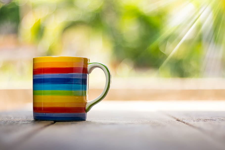 white and multicolored rainbow print ceramic mug, cup, top, view