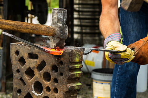 man holding forging iron, forge, blacksmith, hammer, fire, craft HD wallpaper