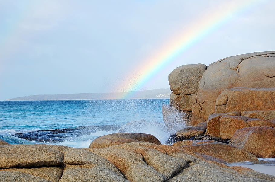 rainbow on body of water near brown rocks, beach, australia HD wallpaper
