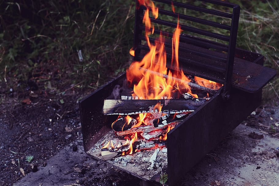 brown metal grill with firing firewood, burning woods on black steel case HD wallpaper