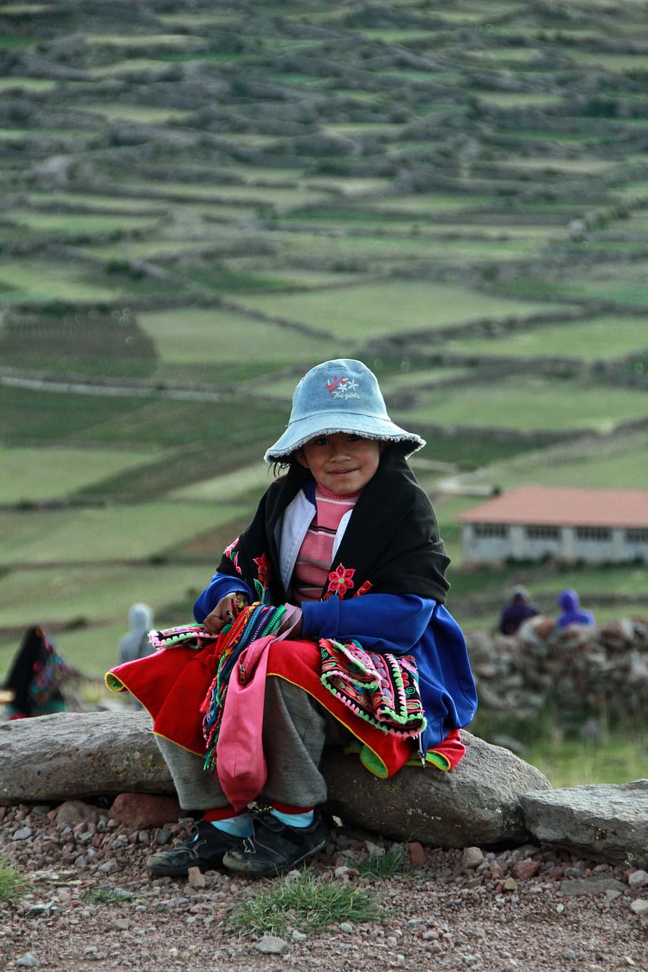 girl sitting on stone, Titicaca, Peru, Andes, Island, Uros, floating