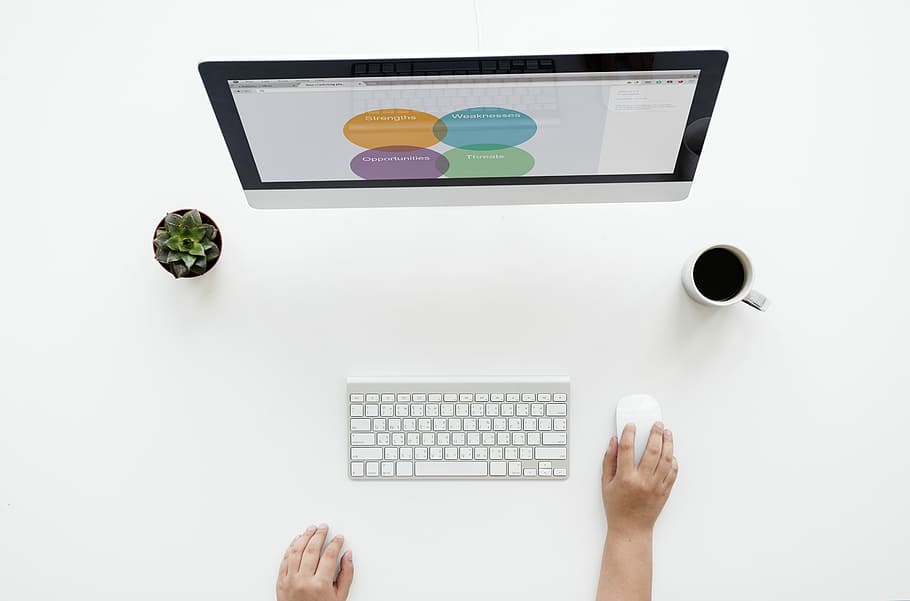 person using iMac on table, apple, keyboard, cup, mouse, technology HD wallpaper