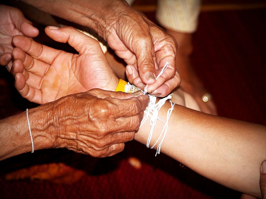 person holding white textile tied on person's arm, hand, care HD wallpaper