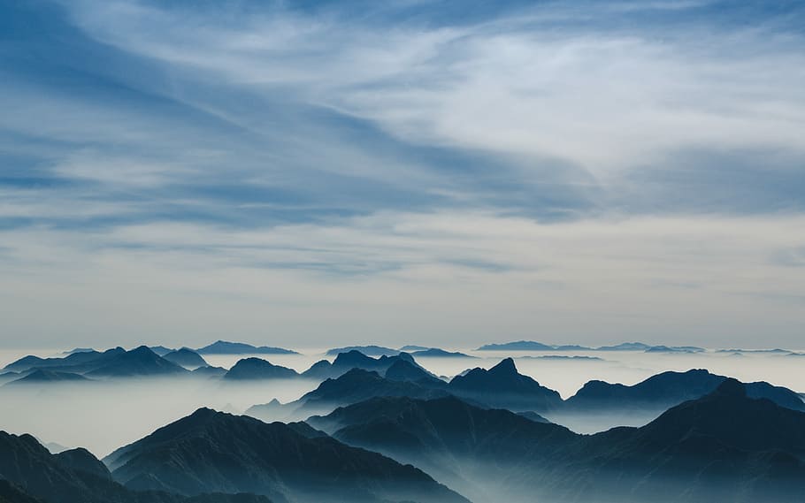mountains under cloudy sky, aerial photo of mountains covered with clouds HD wallpaper