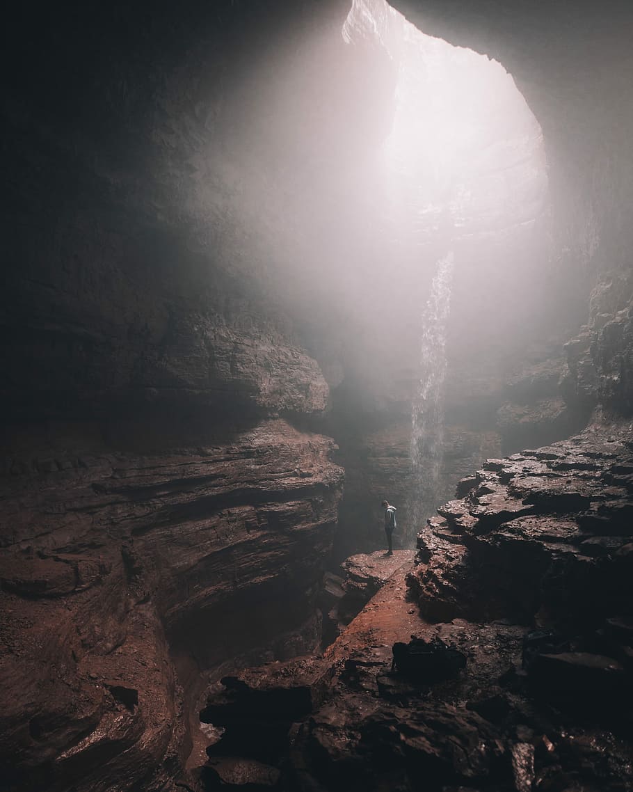 time lapse photography of person standing, man on cliff inside cave HD wallpaper