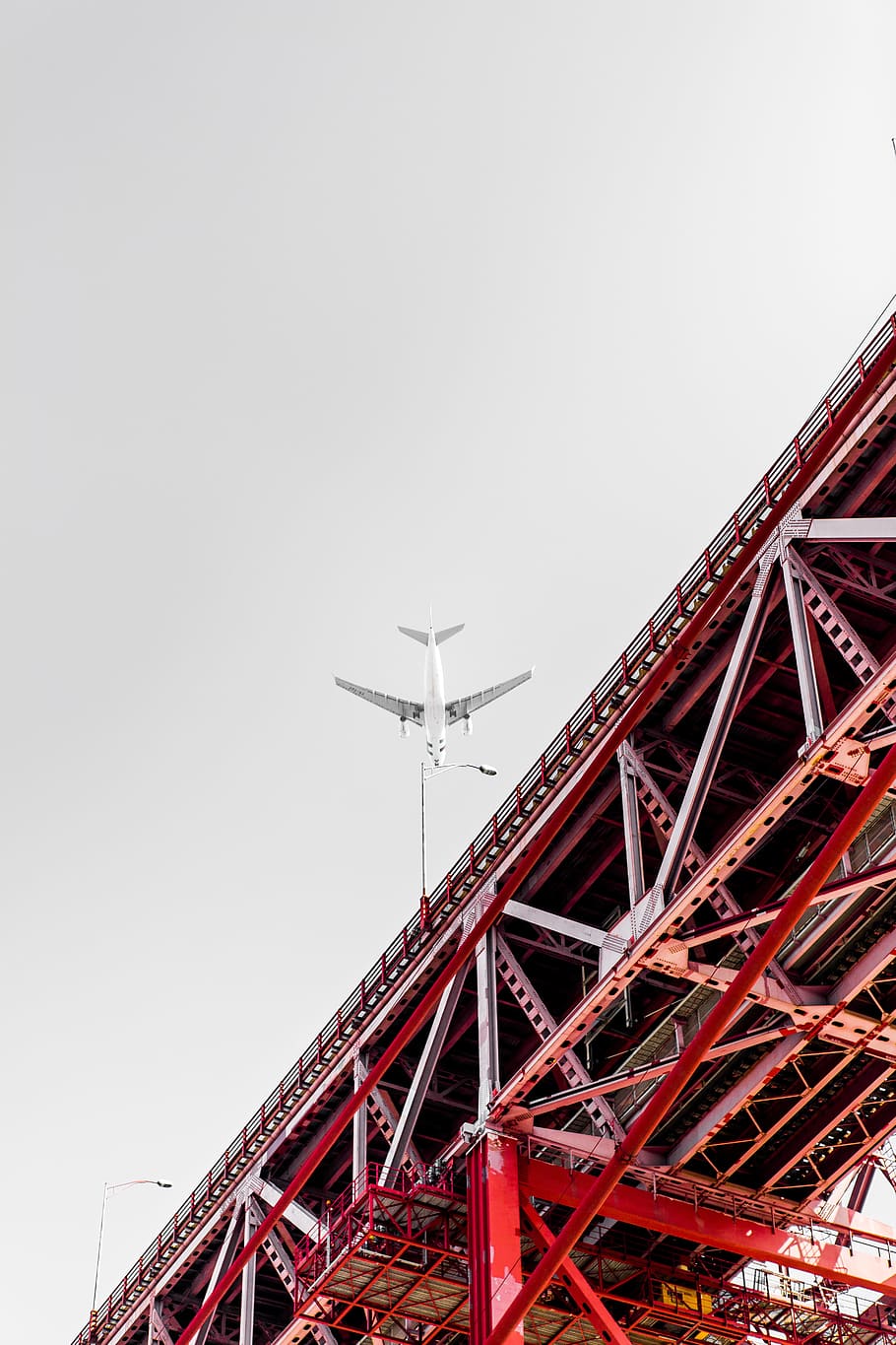 low angle photography of transportation plane above the bridge, white airplane flying over red metal bridge HD wallpaper