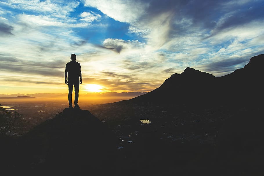 silhouette of man on top of mountain, valley, cliff, hill, sunset HD wallpaper