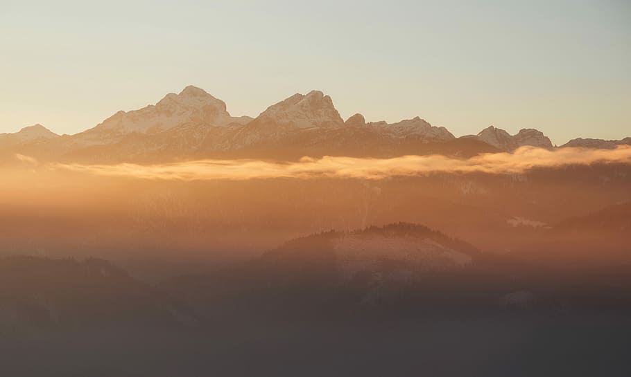 mountain covered by clouds, aerial photography of snow-capped mountains at sunset HD wallpaper