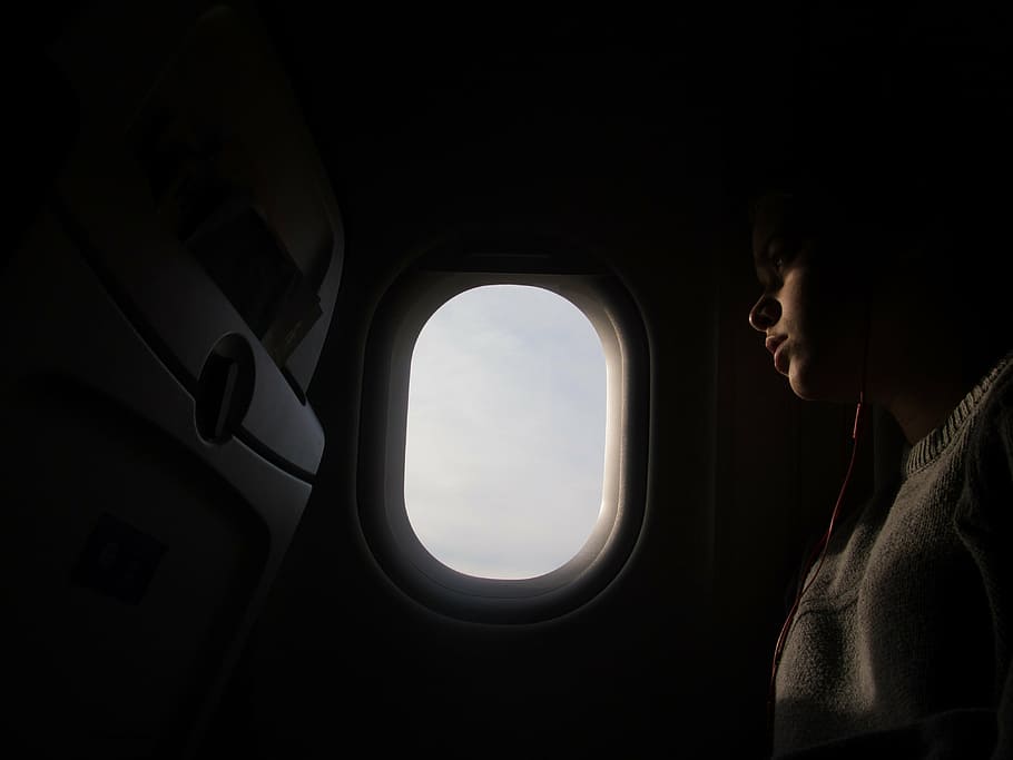 person sitting inside aircraft near window, woman, wearing HD wallpaper