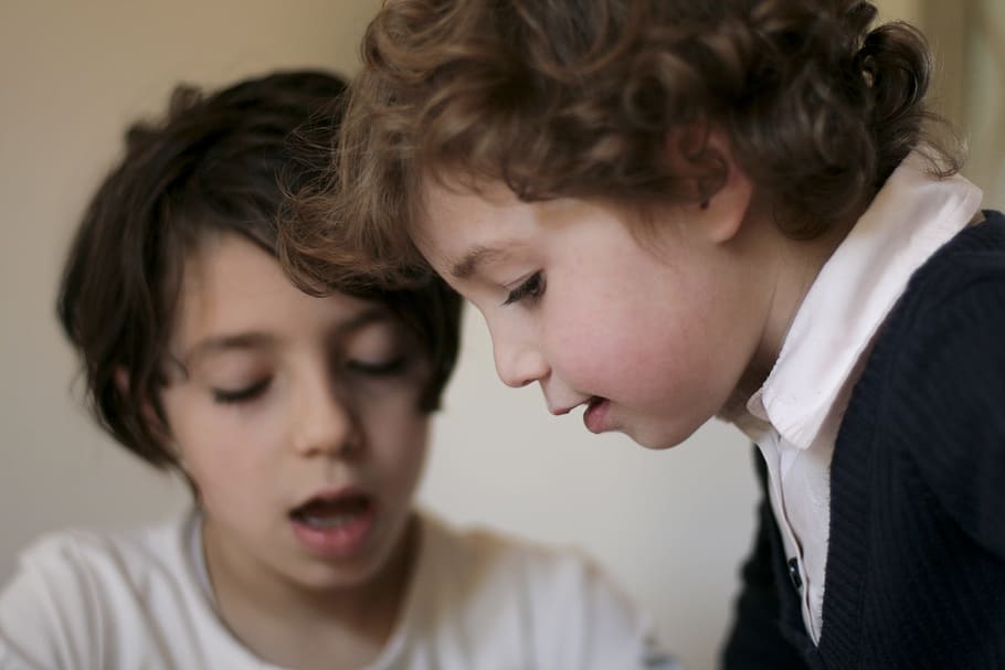 boy in beige crew-neck top with mouth open beside boy wearing black and white collared shirt HD wallpaper