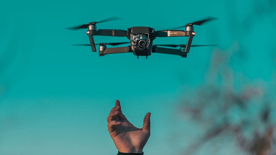 tilt shift lens photo of mini drone, black quadcopter drone floating on air shallow focus photography HD wallpaper