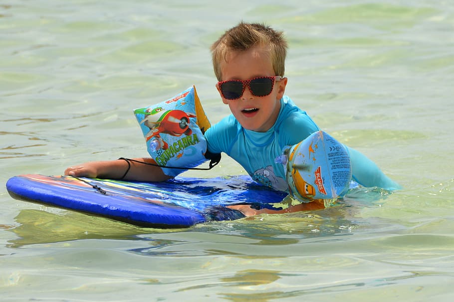 boy holding blue surf board while in water, child, people, surfboard HD wallpaper