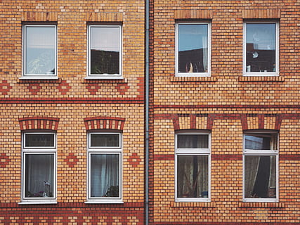orange and red brick wall with mirrors, brown brick building HD wallpaper