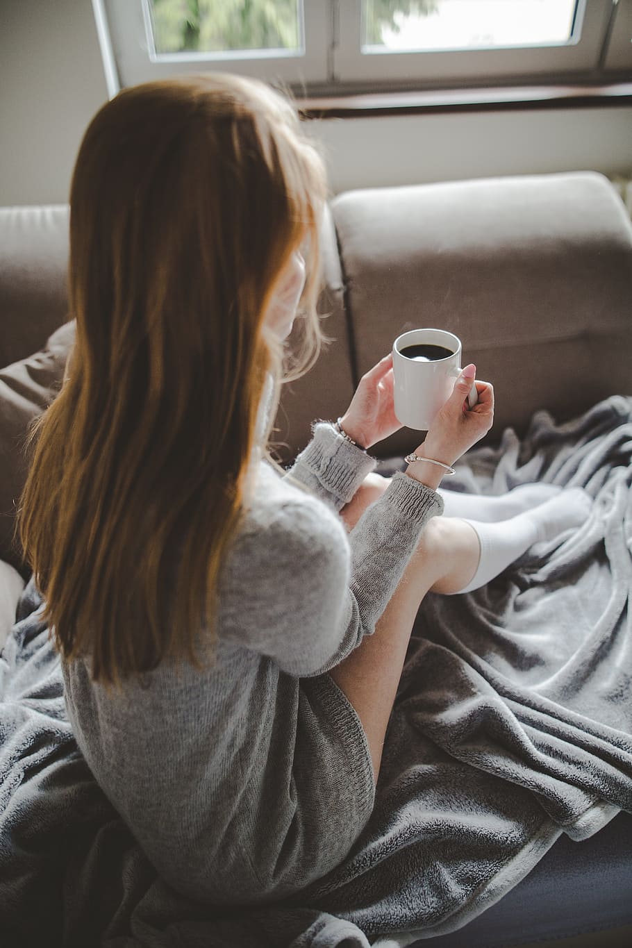 women's grey knit long-sleeve mini dress sitting on grey textile holding ceramic cup, HD wallpaper