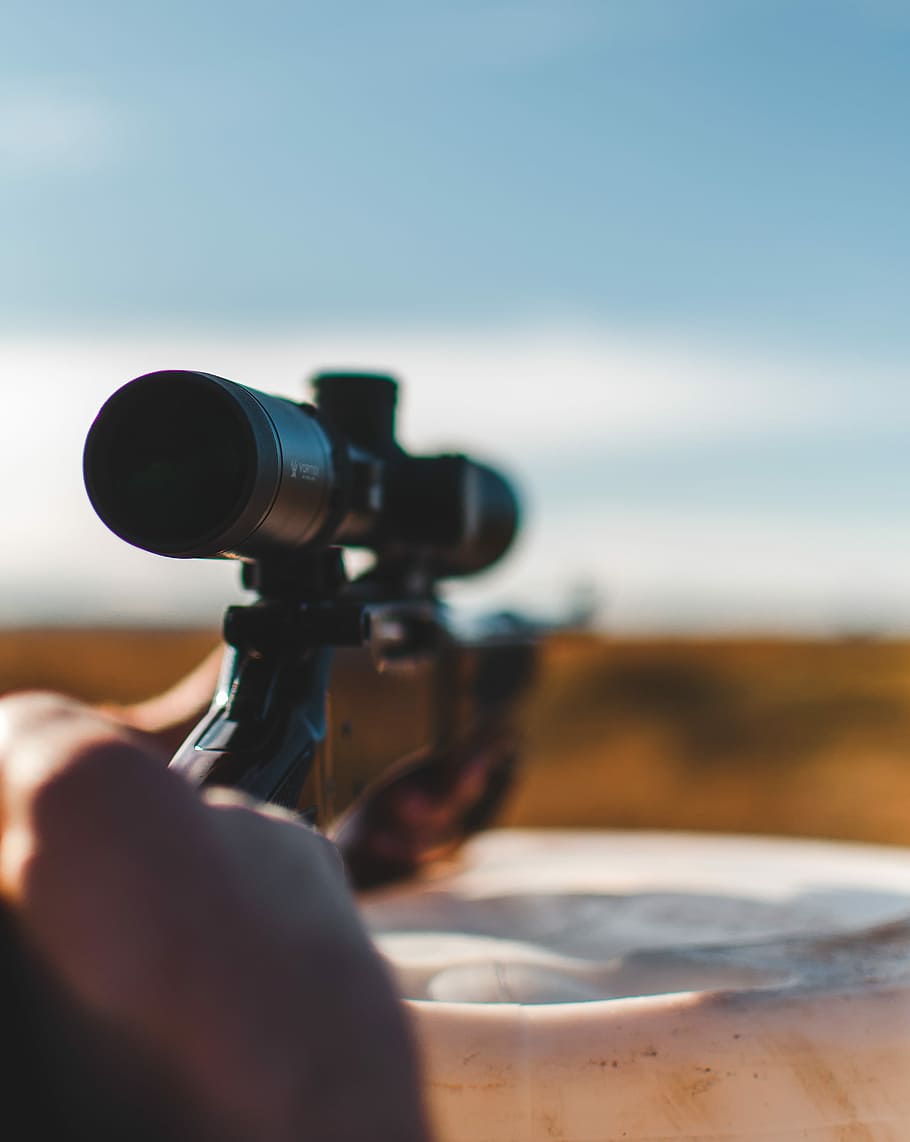 person holding black hunting rifle, shallow focus photography of sniper rifle, HD wallpaper