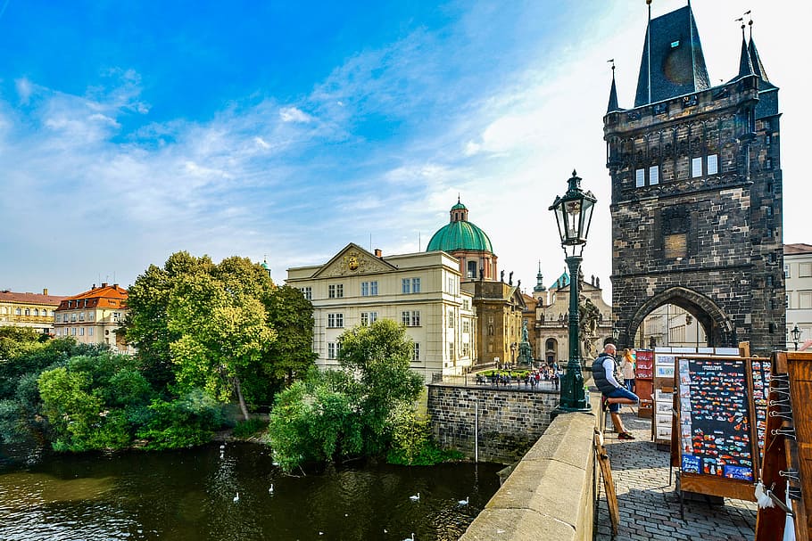 person leaning on concrete railing beside arch building \, prague HD wallpaper