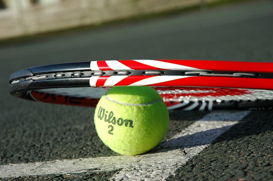 green Wilson tennis ball under tennis rack, tennis racket, sport