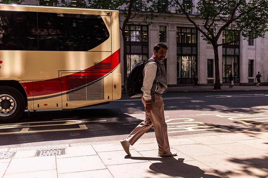 man walking on sidewalk, man standing near bus, street, coach HD wallpaper