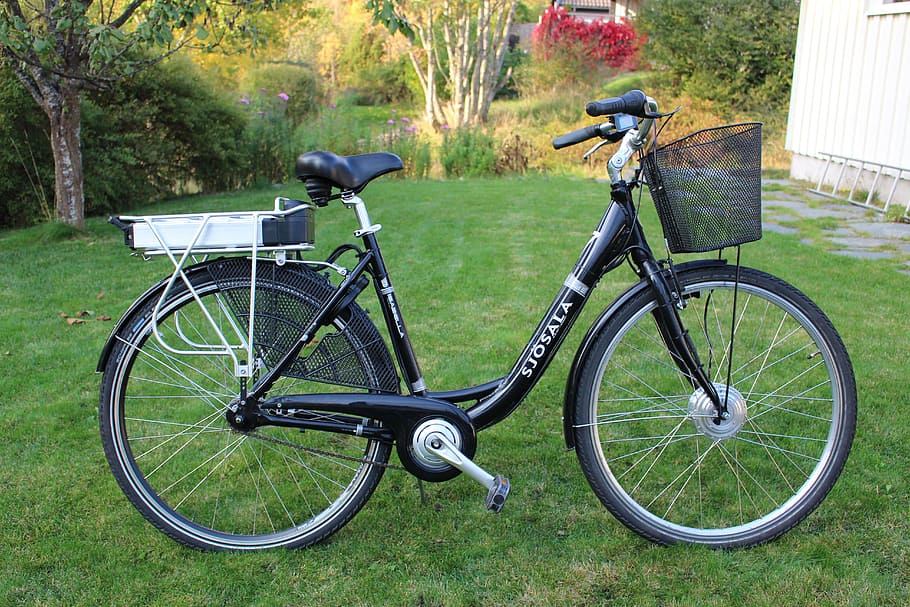 black step-through bicycle on green grassfield, electric, women's bicycle